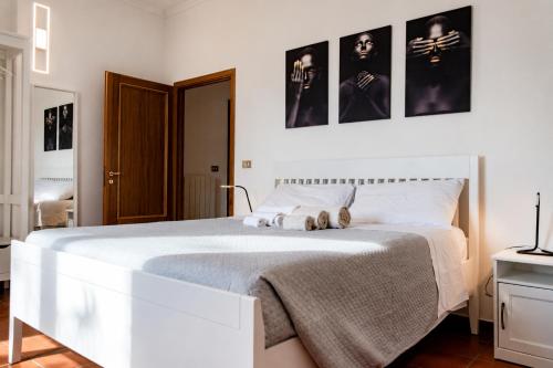 a bedroom with a white bed with two teddy bears on it at Rooftop Madreperla in Taranto