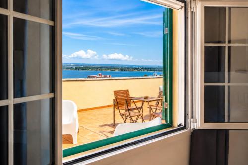 a window view of a patio with a table and chairs at Rooftop Madreperla in Taranto