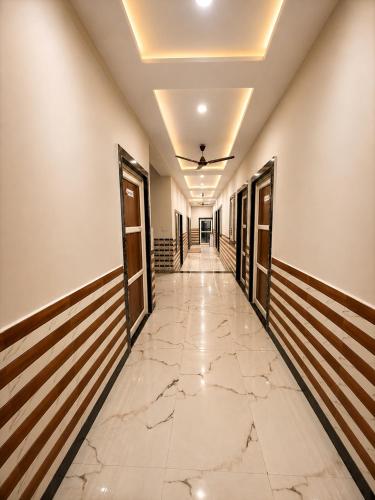 a corridor of a building with a marble floor at Bhagwan krishan kutir in Govardhan