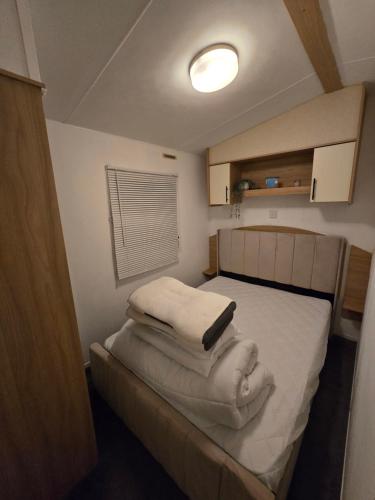 a bedroom with a bed with towels on it at D&D Getaways in Hull