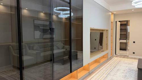 a living room with a glass wall at Zafran Platinum Apartments in Dushanbe