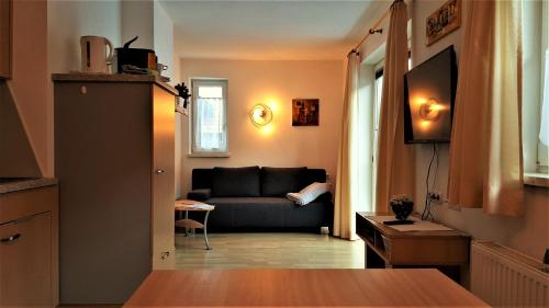 a living room with a couch and a table at Ferienhaus Gundi in Pettneu am Arlberg