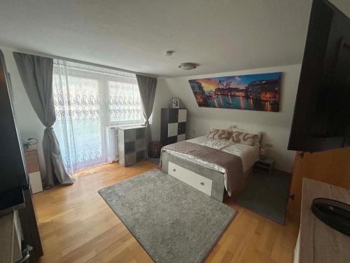 a bedroom with a bed and a large window at Adriaapartman in Bad Wörishofen