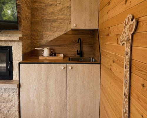 a kitchen with a sink and a counter top at Malesia Eko Resort in Peje
