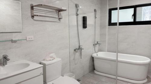 a bathroom with a shower and a toilet and a sink at Musun Stay in Ch'ao-yang