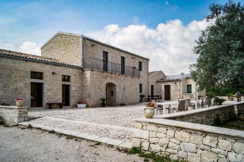 an external view of a stone building with a patio at Tre Balate Natura e Relax in Modica