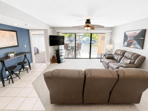 a living room with a couch and a table at Serenity Pointe Boat Slip in Osage Beach