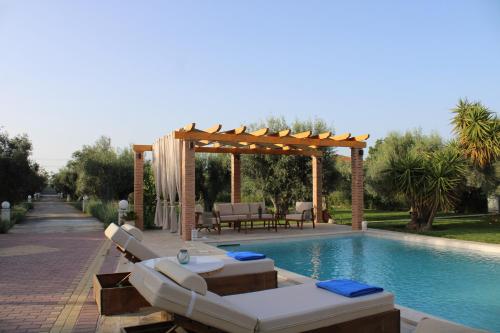 a pool with a gazebo and a swimming pool at Gravanis Resort in Sikáminon