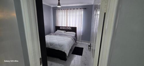 a small bedroom with a small bed in a window at The Amanda Bed & Breakfast in Migori
