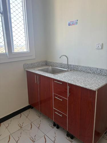 a kitchen with a sink and a counter at Modern studio apartment in Mogadishu