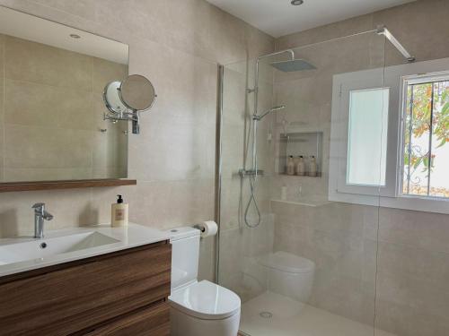 a bathroom with a shower and a toilet and a sink at El Olivo in Níjar