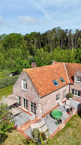 an aerial view of a brick house with a patio at House C - North Sea Stays in De Haan