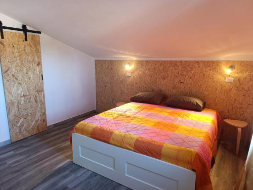 a bedroom with a bed with a colorful blanket at Pollino House in Morano Calabro