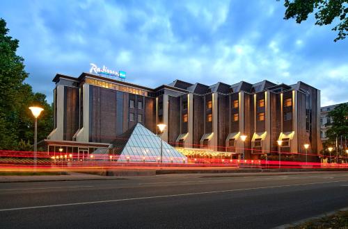 a building with a pyramid in front of it at Radisson Blu Ridzene Hotel, Riga in Riga