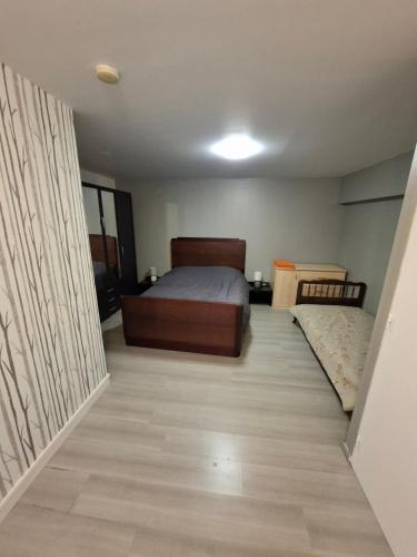 a bedroom with a bed and a wooden floor at Gite saint marc in Mer