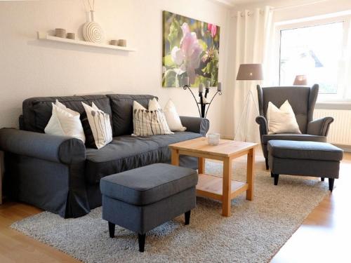 a living room with a couch and two chairs and a table at Apfelblüte - Ferienhaus - ABC321 in Klein Warin