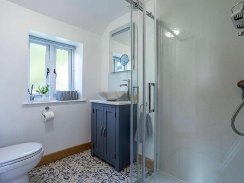 a bathroom with a sink and a glass shower at 1 Bed in Axminster oc-82604 in Chardstock