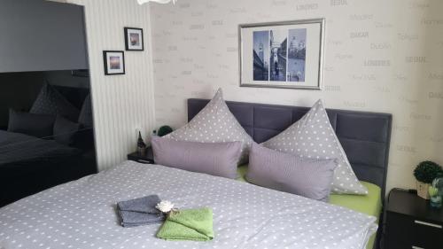 a bedroom with a bed with polka dot pillows at Ferienwohnung Sonnenblick in Bischofswerda