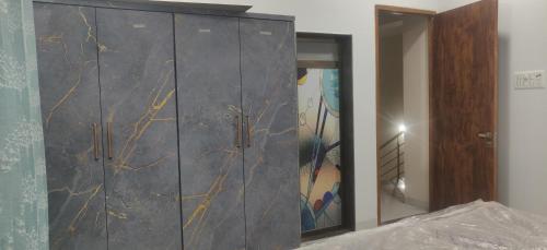 a gray cabinet with a mirror in a room at Orchard Suite in VÄngaon