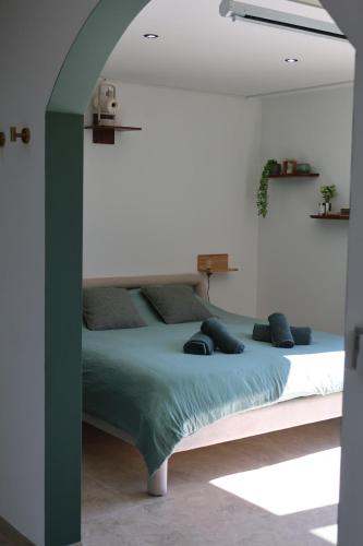 a bedroom with a large bed in a room at Le Nid du Cortil in Theux