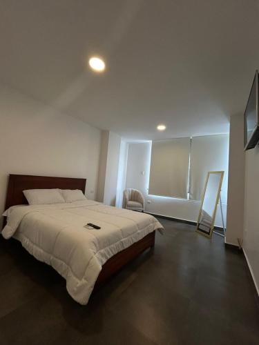 a bedroom with a large bed in a room at FinlandHouse in Puerto López