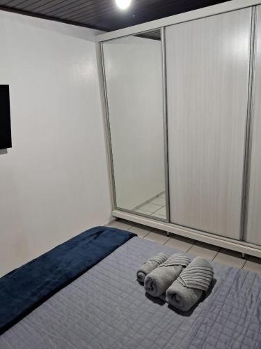 a room with a bed with three pillows on it at Loft em São José in São José