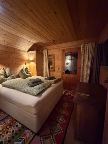 a bedroom with a bed in a wooden cabin at ChaletFeeling im Salzkammergut in Strobl