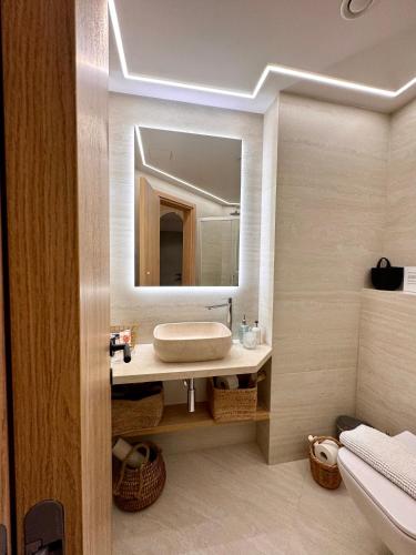 a bathroom with a sink and a mirror at Olive Apartment in Tala