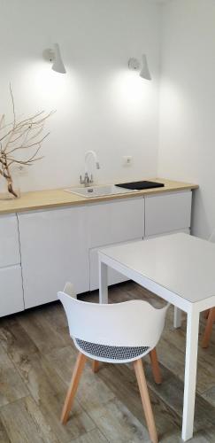a kitchen with a white counter and a white desk at Catia's Apartments, Clima, Mare&Spiaggia 700mt in Porto San Giorgio