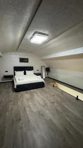 a bedroom with a large bed in an attic at Mini House in Shahumyan