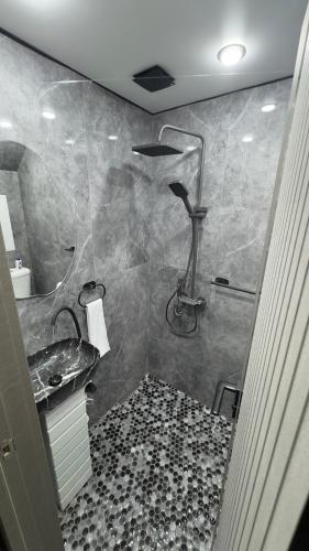a bathroom with a shower and a sink at Mini House in Shahumyan