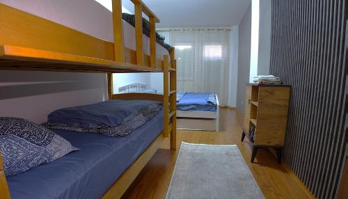 a bedroom with two bunk beds and a dresser at Prishtina Host in Prishtinë