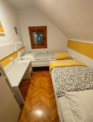 a small room with two beds and a sink at River house HRIB in Preddvor
