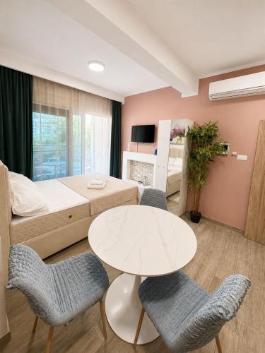 a room with a bed and a table and chairs at Blue Bay Studio in Bečići