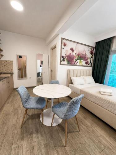 a living room with a bed and a table and chairs at Blue Bay Studio in Bečići