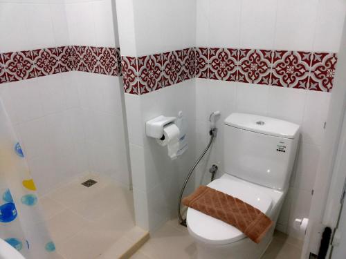 a bathroom with a toilet and a shower at The Duck in Phuket Town