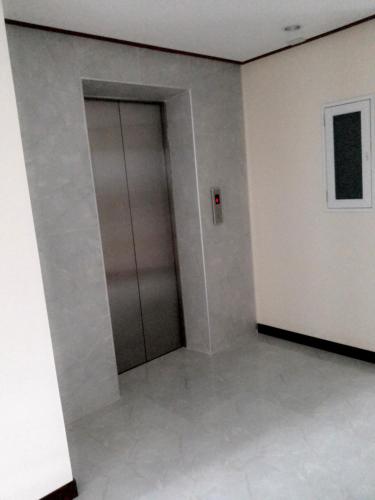 an empty room with a door in a building at The Duck in Phuket Town