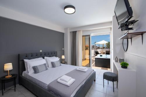 a bedroom with a bed and a view of a patio at United Cretan Villas & Spa in Agia Marina Nea Kydonias
