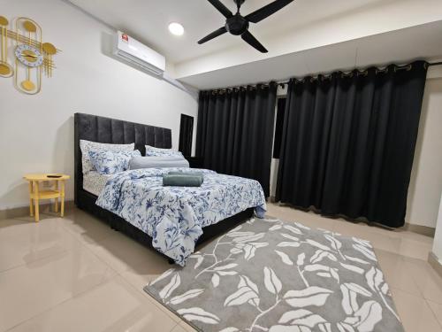 a bedroom with a bed and a ceiling fan at DH Villa in Batu Caves