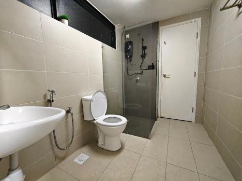 a bathroom with a toilet and a sink and a shower at DH Villa in Batu Caves