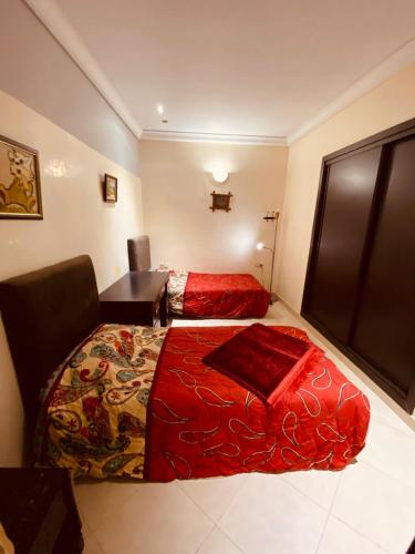 a hotel room with a bed and a desk and a bed sidx sidx at Meknes Hamria centre ville only families and forneigners in Meknès