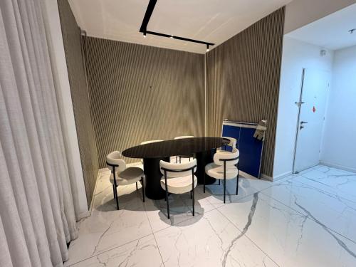 a black table and chairs in a room at Sky High 15 Choose Between 2 Luxury Penthouses in Beer Sheva