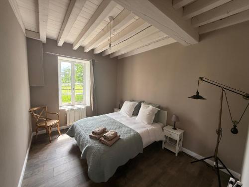a bedroom with a bed with two towels on it at La Motte Feuilly in La Motte-Feuilly