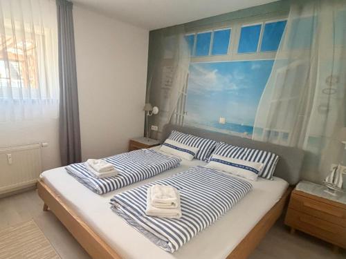 a bedroom with two beds with towels on them at Ferienresidenz Seegarten Andrea - Seezugang und Schwimmbad in Bodman-Ludwigshafen