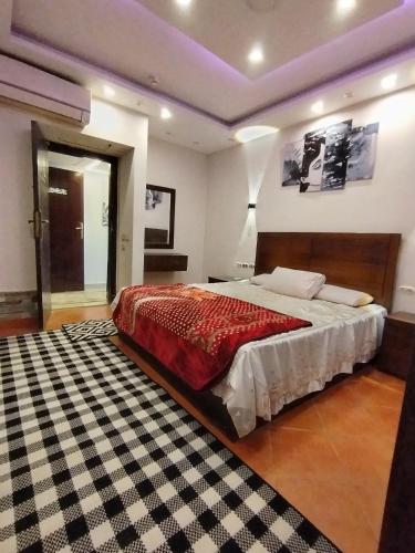 a bedroom with a large bed and a rug at Porto Sokhna Pyramids - For Families Only vip in Ain Sokhna