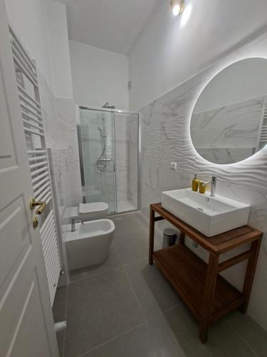 a bathroom with a sink and a shower and a tub at Dimora Tre Marie in LʼAquila