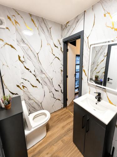 a bathroom with a white toilet and a sink at 2BR Central Apt - Parking -2 Baths - Bars & Trains in Liverpool