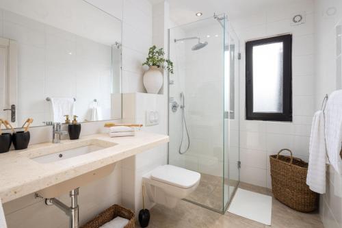 a bathroom with a toilet and a glass shower at Sunset Terrace Vinisce in Vinišće
