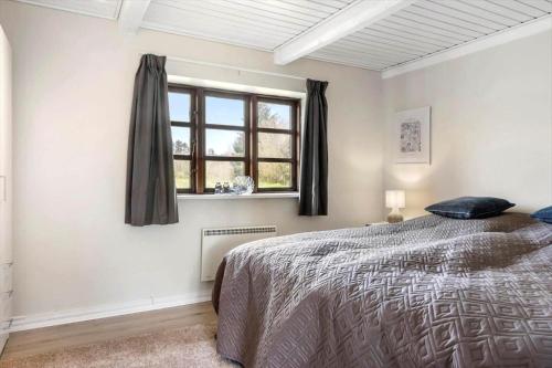 a bedroom with a bed and a window at LF11979-Struer-Havstokken-9-a in Vemb