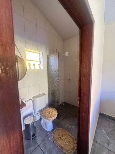 a bathroom with a toilet and a sink at Chalé do coiote! in São Roque de Minas